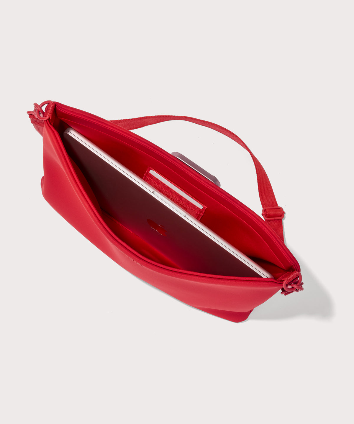 16 inch laptop shoulder bag in a fiery, saturated red leaning toward orange seen from the top down view showing interior.