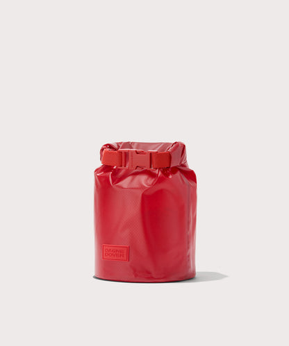 Dagne Dover Rae Roll-Top Dry Bag in a fiery, saturated red leaning toward orange seen from an angle.