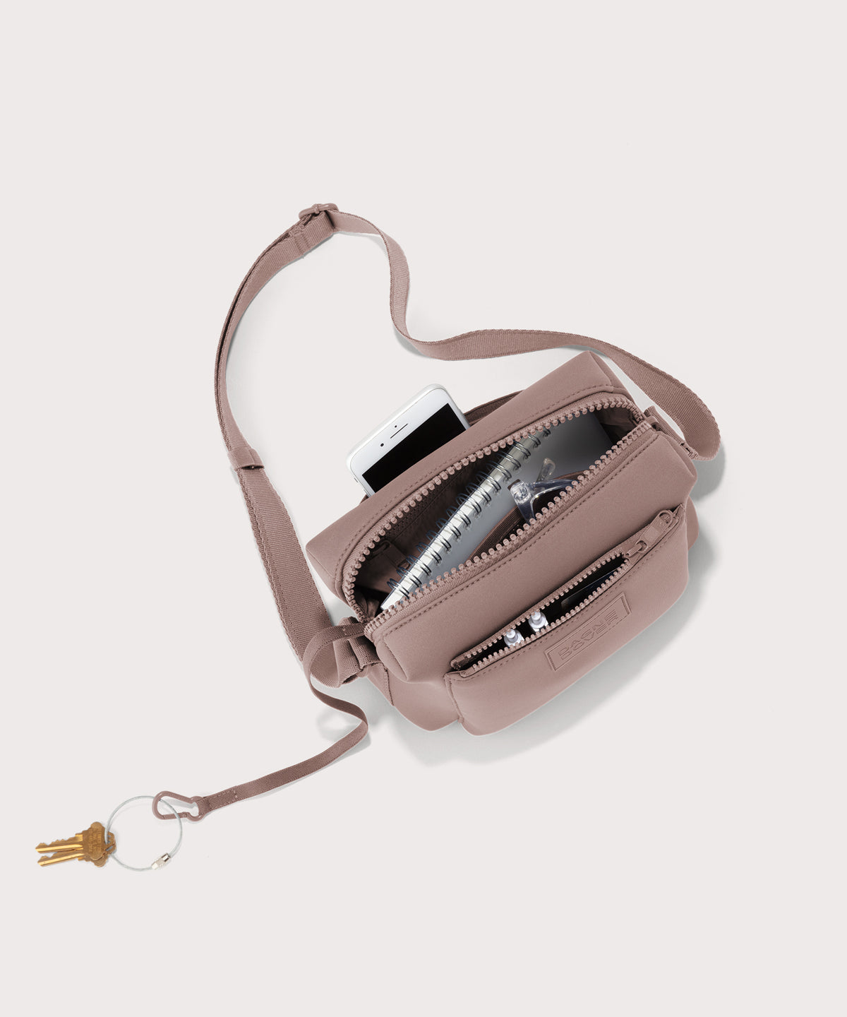 Dagne Dover Micah Crossbody in pink seen from above, showing the interior air mesh pocket.