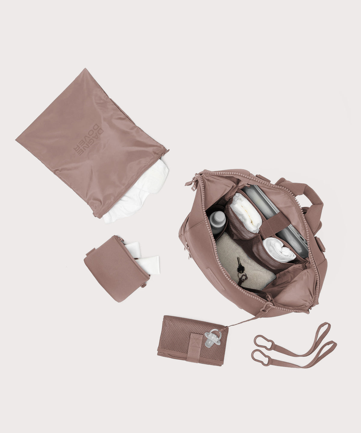 Dagne Dover Large Indi Diaper Backpack in pink showing it's water resistant bag, interior pockets, and changing mat.