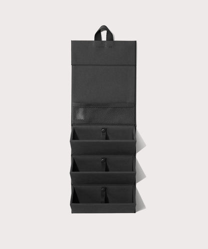 Dagne Dover Remi foldable glasses holder in black hung up.