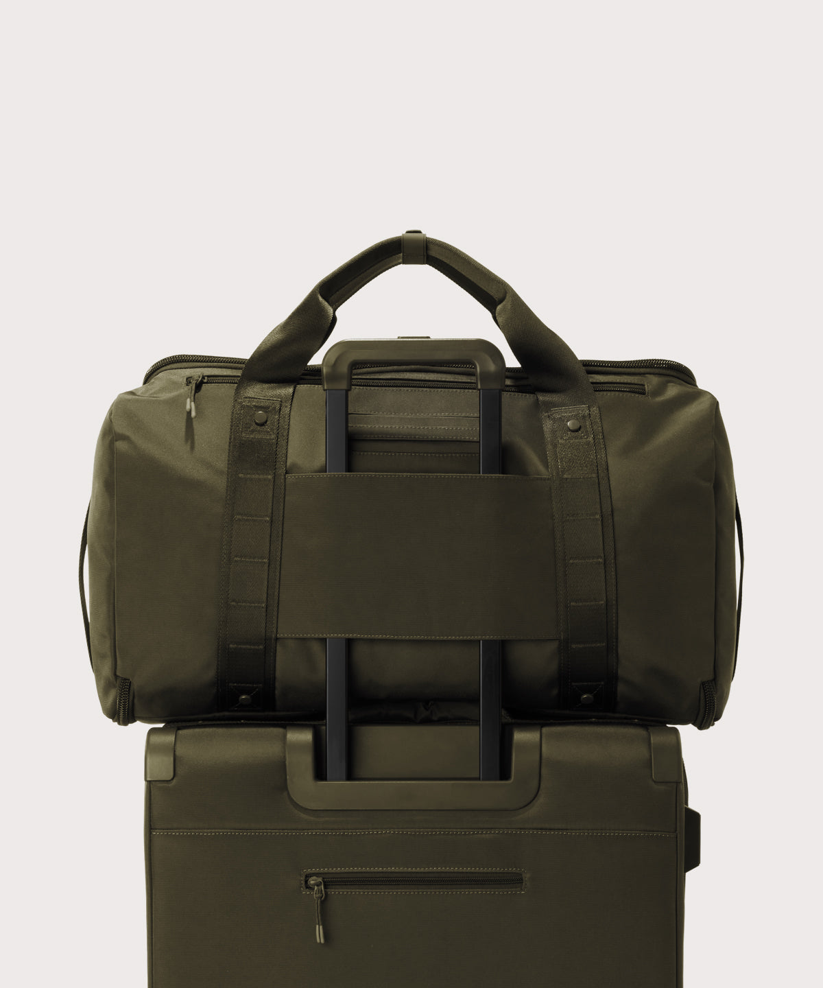 Back view of Monaco garment duffle in dark green on luggage handle