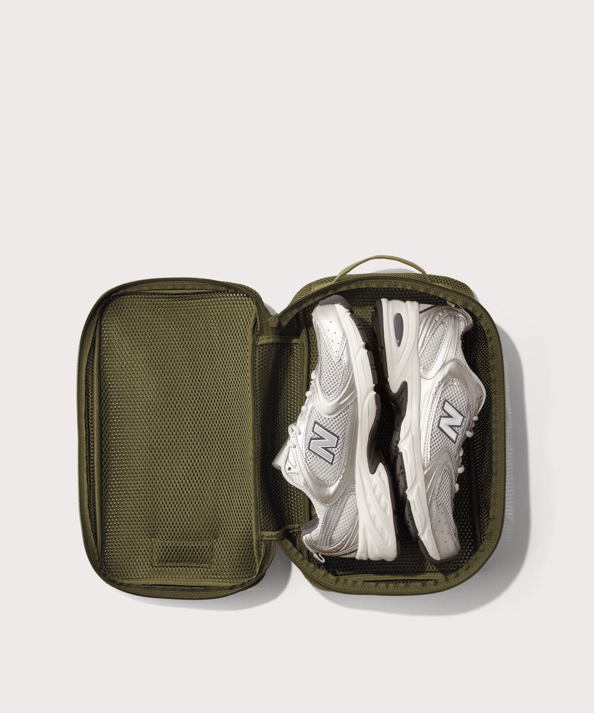 medium Roma packing cube in dark green open with jeans inside